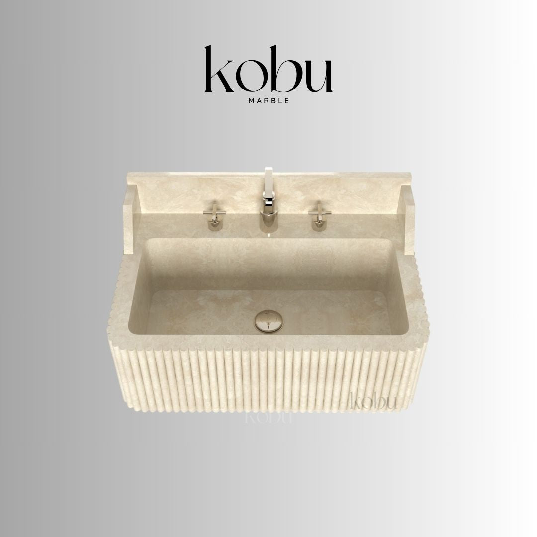 Close-up of warm-toned travertine texture on wall-mounted sink