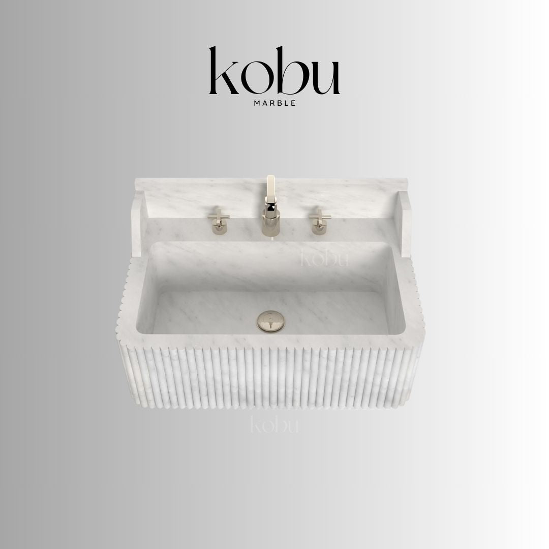 Side profile of wall-mounted white marble sink in modern bathroom