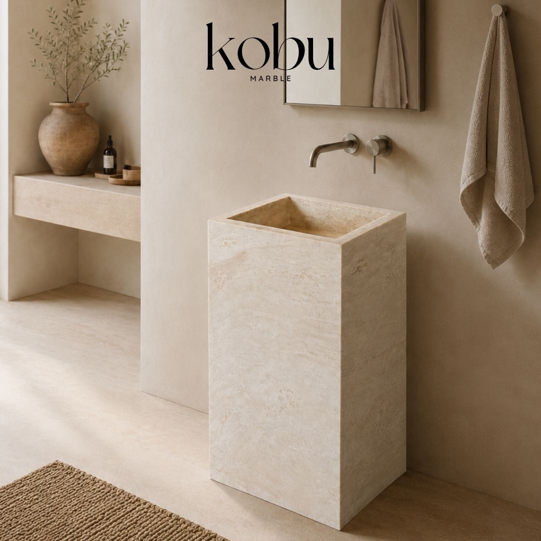 Front view of a 24-inch travertine stone pedestal sink with an integrated rectangular basin.