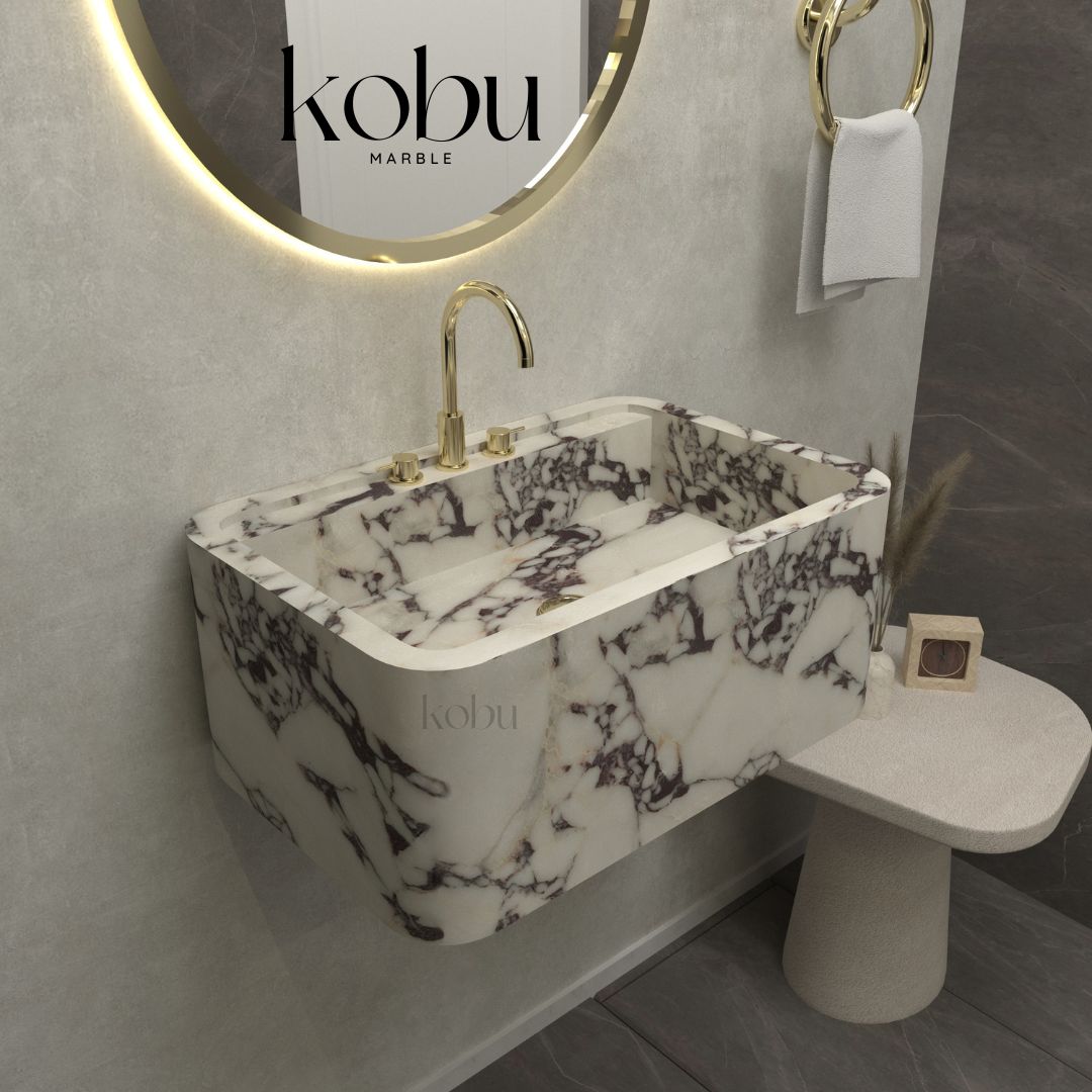 Side angle of a luxury Calacatta Viola marble sink, featuring smooth Italian stone craftsmanship.