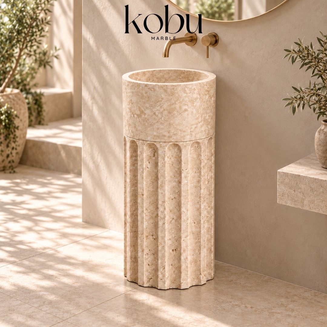 Handcrafted travertine pedestal sink featuring a modern two-piece natural stone design for luxury bathrooms.