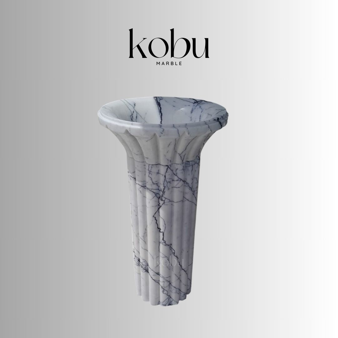 Front view of 2-piece lilac marble pedestal sink with sculptural base