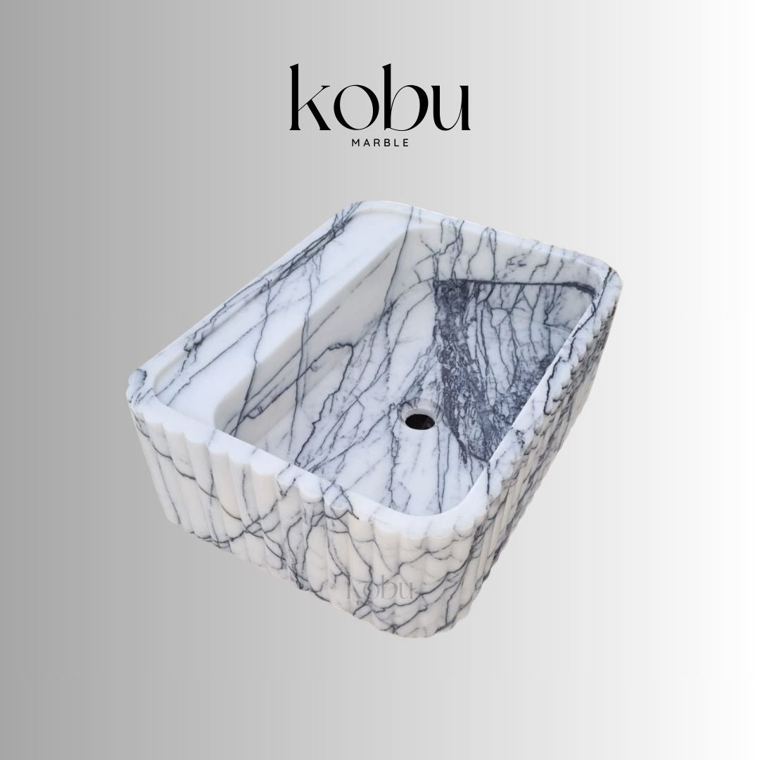 Front view of 24-inch wall mounted lilac marble sink with soft veining