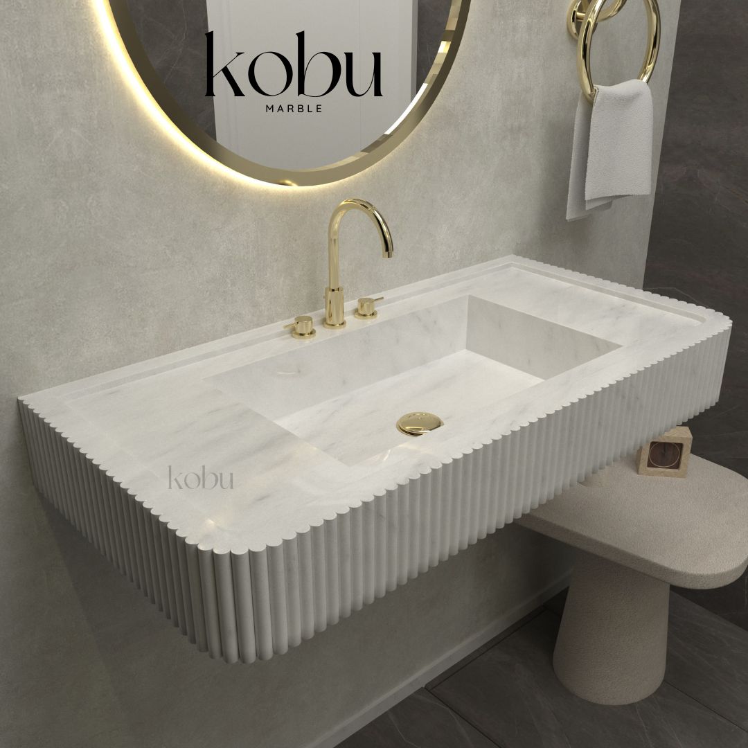 Front view of handcrafted fluted white marble sink, showcasing elegant natural stone texture.